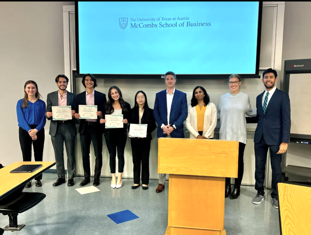 Case competition winners standing with judges.